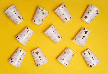 Paper cups on yellow background.
