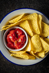 Tortilla chips and red tomato salsa dip. Mexican nacho chips.