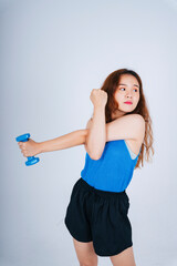 Naklejka premium Asian woman wearing blue shirt using dumbbell isolate on white background.