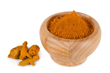 Turmeric powder spice heap in a wooden bowl with turmeric roots isolated on a white background.