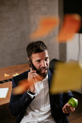 Businessman in conference room use sticky notes on glass wall. Handsome businessman making a business plan..