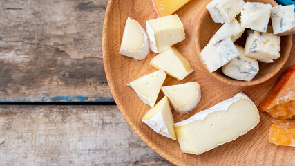 Close up image of various kinds of cheese on board