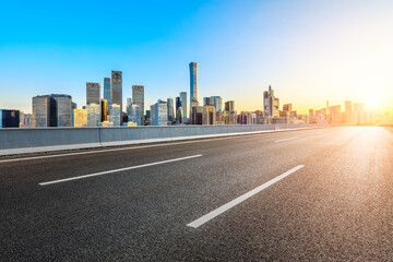 Fototapeta premium Asphalt road and modern city commercial buildings in Beijing at sunrise,China.