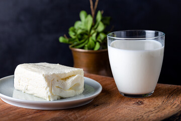 Turkish creamy dairy product. Clotted cream (butter cream) for Turkish breakfast with glass of milk.
