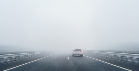 a car on the freeway in the heavy fog