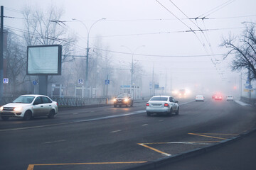 Fototapeta na wymiar Cars on the road in fog city