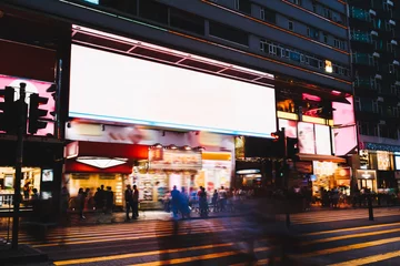 Fotobehang Crowded street with glowing billboard in night city © BullRun