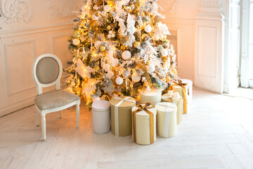 luxurious expensive light interior living room in a royal style decorated with a very beautiful Christmas tree and large windows