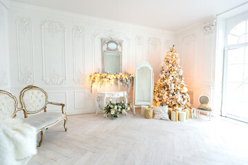 luxurious expensive light interior living room in a royal style decorated with a very beautiful Christmas tree and large windows