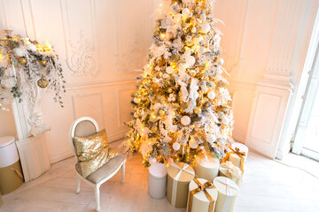 luxurious expensive light interior living room in a royal style decorated with a very beautiful Christmas tree and large windows