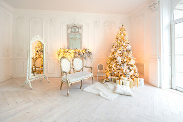 luxurious expensive light interior living room in a royal style decorated with a very beautiful Christmas tree and large windows