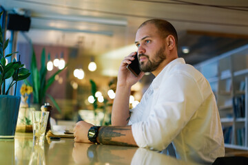 Focused man having conversation on smartphone