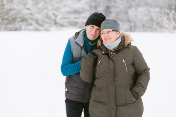Fototapeta na wymiar Close up portrait of happy beautiful senior couple posing at winter outdoors. Mature man and woman in love