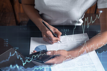 A client in casual wear is signing the contract to invest money in stock market. Internet trading...