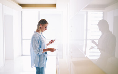 Woman browsing smartphone in lounge