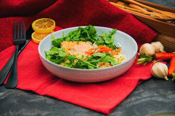 Fresh and tasty tartare of raw salmon prepared with salmons eggs and vegetables on top served in white plate