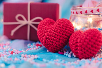 heart shape, Foam beads, feather, gift box and light decorative bokeh on blue cloth. Love, Valentine and holiday concept.