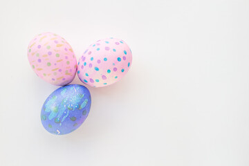 Set of colorful hand-painted Easter eggs. Bright children's drawings on Easter eggs top view on a white background. Happy Easter holiday and fun for children