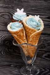 Wafer cones filled with marshmallows. With white and dark chocolate. Decorated with pastille snowflakes.