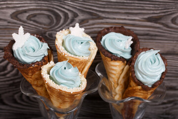 Wafer cones filled with marshmallows. With white and dark chocolate. Decorated with pastille snowflakes.