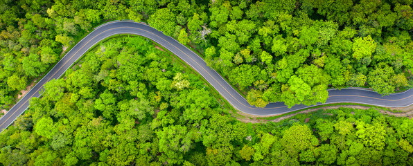 Winding road, top view of beautiful aerial view of asphalt road, highway through forest and fields...