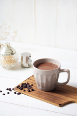Fototapeta na wymiar cup of hot chocolate with white wooden background