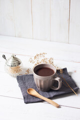 cup of hot chocolate with white wooden background