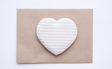 Obraz na płótnie Canvas Tissue heart on craft envelope. Eco friendly valentine day