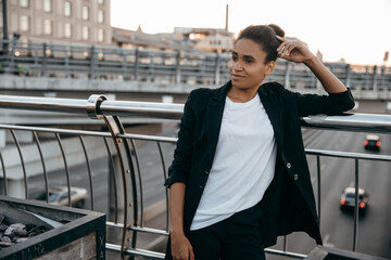 Portrait of beautiful African student  wearing suit  in urban city background. 