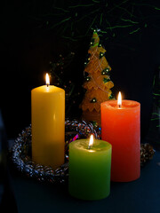 burning candle and christmas tree with ornaments 