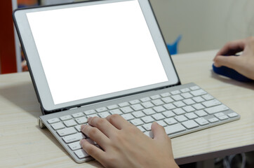 girl using a computer keyboard. Studying online at home.Playing computer games and social media. White mockup with blank screen.