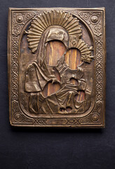 Antique copper stamping icon on a black background.