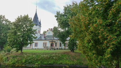  Olszanica,  Poland - September 05, 2018: Old small and neat palace, hiding between trees