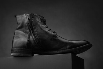 High men's leather boots. Dark background. Fashionable shoes - 404863910