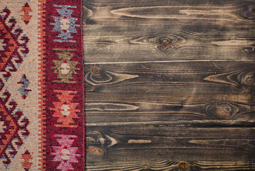 Old Tablecloth with heart on wooden background.