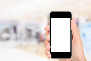 Hand holding the phone tablet on blurred in shopping mall background