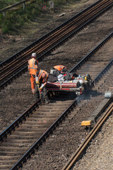 Berlin, Germany - April 19, 2019: Rail track maintenance. A team of railroad workers inspecting and repairing a railway track