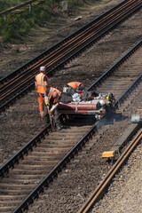 Berlin, Germany - April 19, 2019: Rail track maintenance. A team of railroad workers inspecting and...