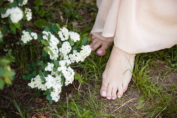 Beatiful pedicure closeup. Woman feet in blooming garden