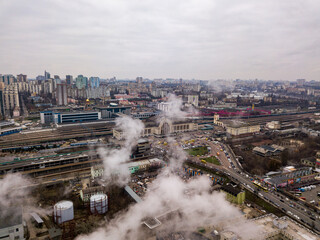 Aerial drone view. The building of the Kiev railway station through the white smoke from the chimneys.