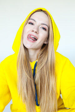 A Young Woman Poses In A Bright Yellow Tracksuit