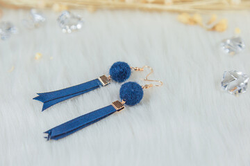  Blue pompoms, blue streamers, and golden metal, these match earrings. Are our own handmade earrings