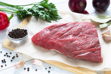 Raw meat beef on cutting board with spices
