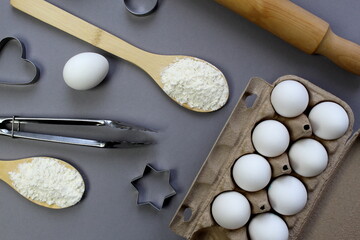 Kitchen utensils for making cookies lie on a gray background