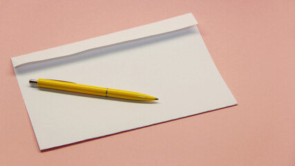 clean white envelope with yellow handle on light background