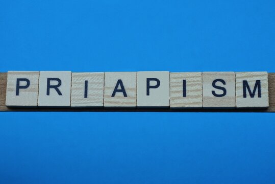 gray word priapism in small square wooden letters with black font on a blue background