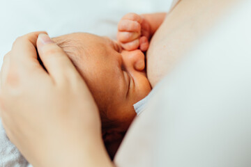 Portrait of newborn hold close at mother s breast, close up. Family, healthy new birth photo....