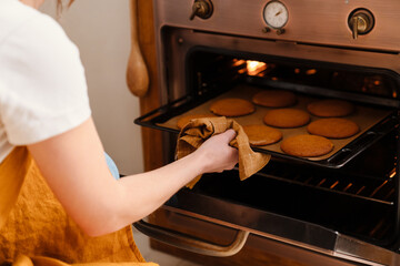 Caucasian pastry chef woman baking cookies at cozy kitchen