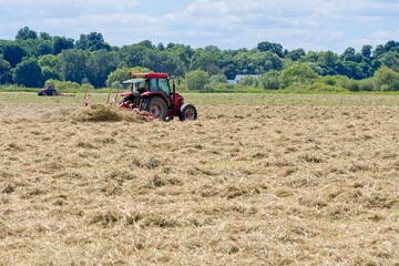Fototapeta premium red tractor working in the field