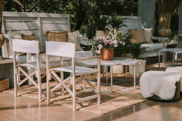 wooden tables and chairs with colorful flowers